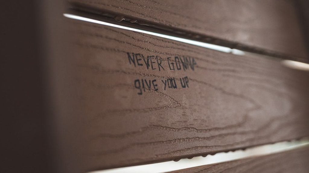 a close up of a wooden door with writing on it